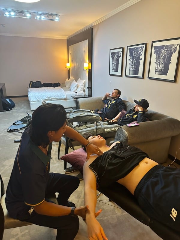 Tristan treating an athlete on a portable table